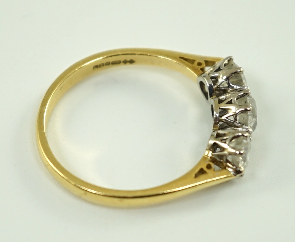 A modern 18ct gold and three stone diamond set ring